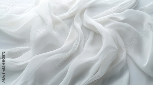 Delicate chiffon fabric blowing in the wind, with translucent layers and light ripples, on white.