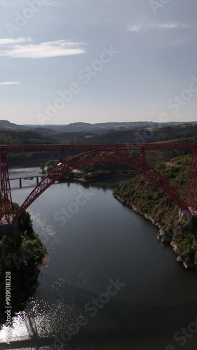 Explore the majestic Garabit viaduct spanning the tranquil Truyere river photo