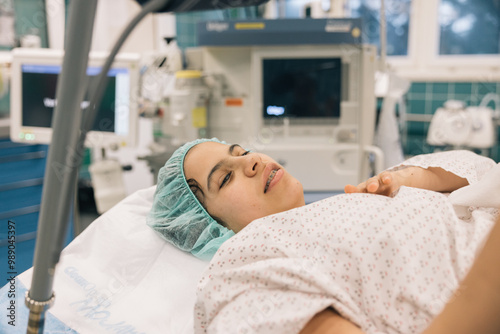 Canvas Print Young patient waking up after an operation in the post anaesthesia recovery unit