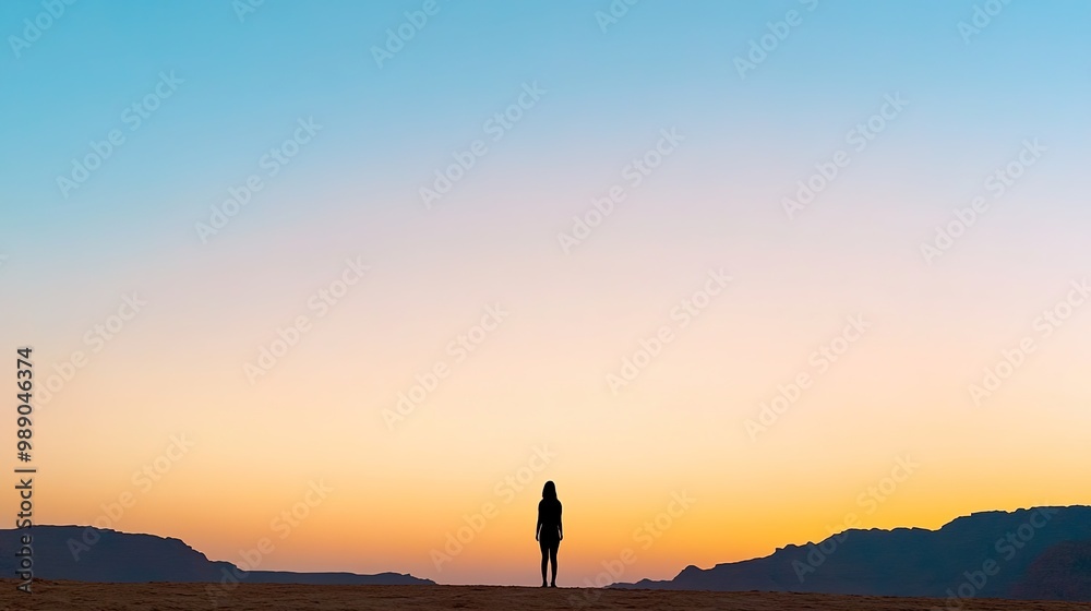 Fototapeta premium Silhouette of a Person Against a Sunset Horizon