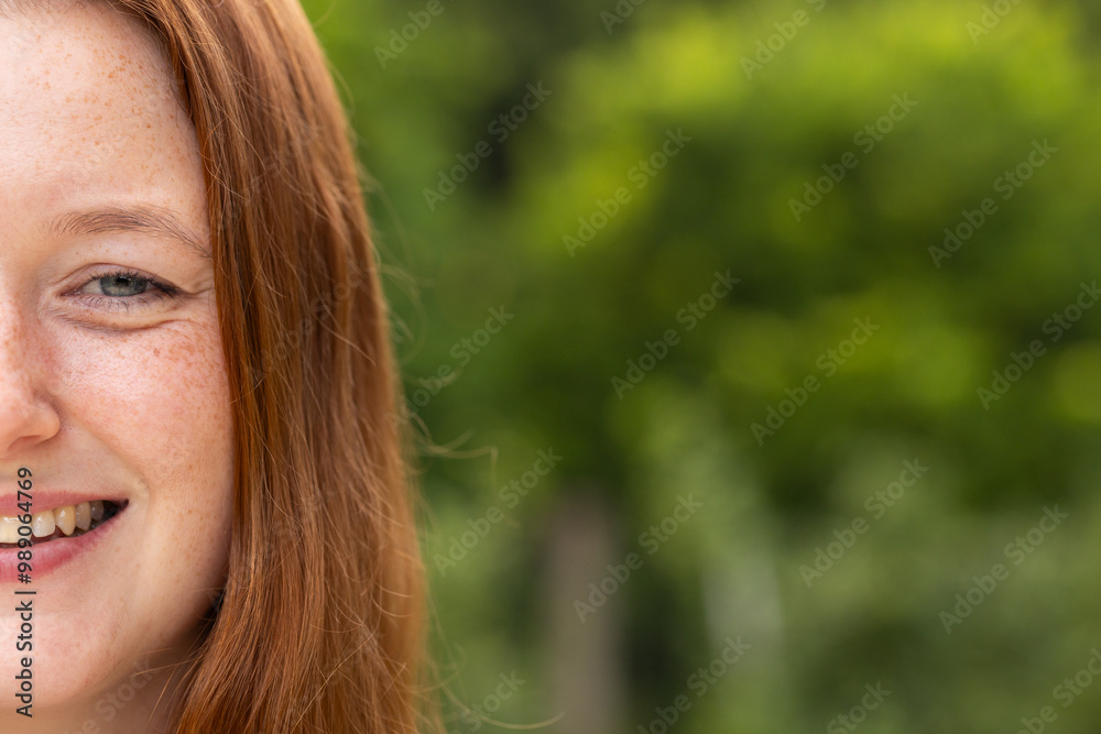 Smiling woman with red hair enjoying outdoor time Smiling woman with red hair enjoying outdoor time