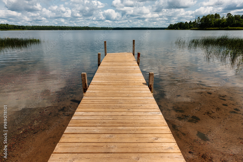 Naklejka premium The morning early August sunshine brightens the small boat pier at Big Muskellunge Lake near Boulder Junction, Wisconsin in Vilas County