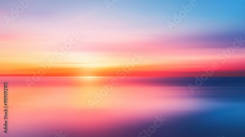 Stunning vibrant horizon with a blurred sunset  where the colors of the sky softly fade from deep orange to soft pink and blue tones