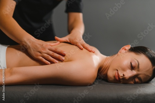 Masseur doing massage on woman back in the spa salon