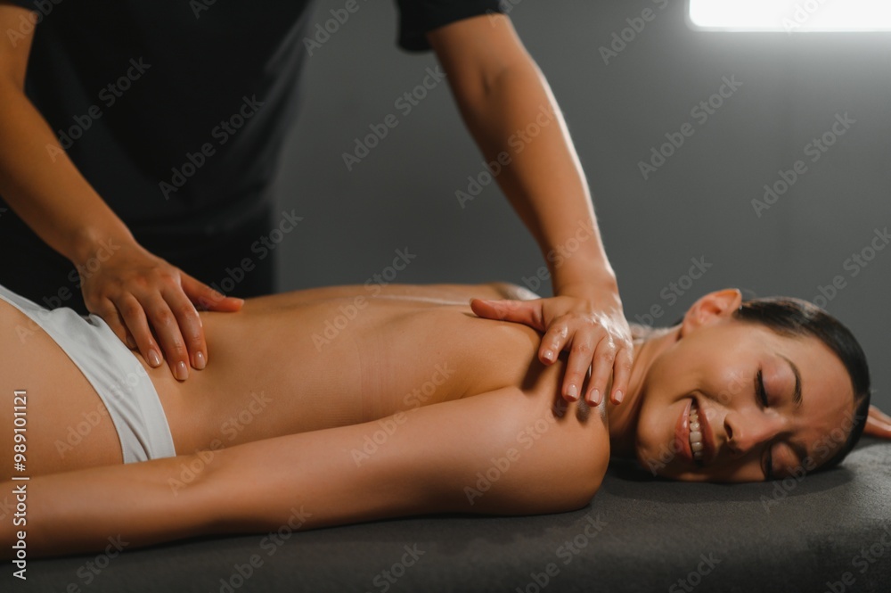 Masseur doing massage on woman body in the spa salon. Beauty treatment concept Masseur doing massage on woman body in the spa salon. Beauty treatment concept