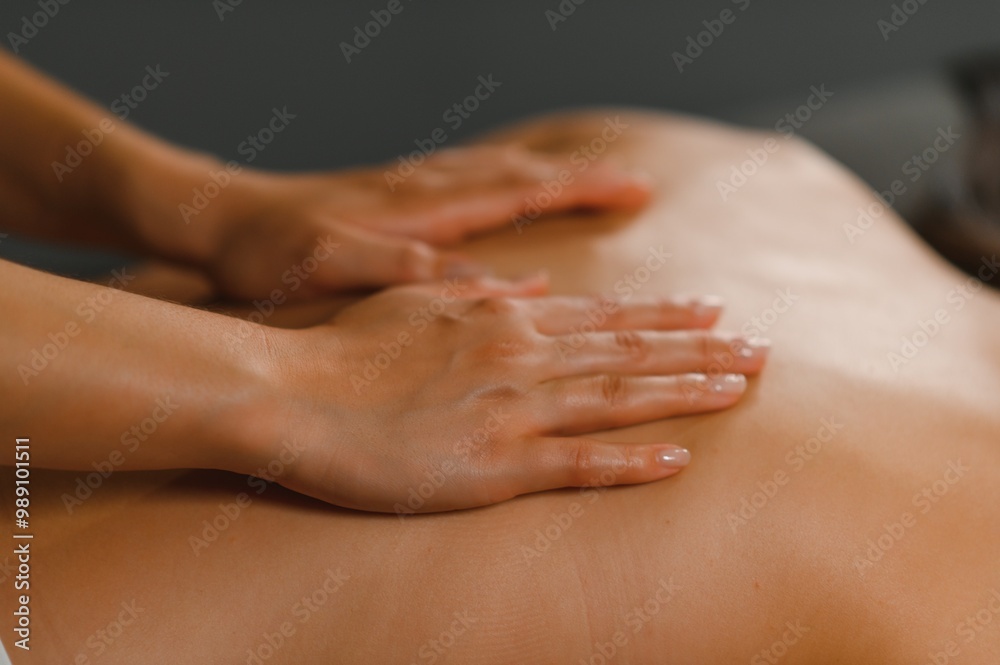 Masseur doing massage on woman back in the spa salon Masseur doing massage on woman back in the spa salon