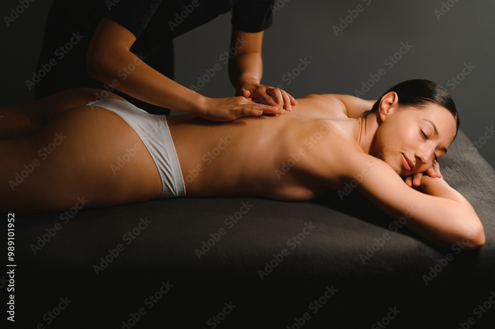 Fototapeta premium Beautiful woman having relaxing in spa massage salon
