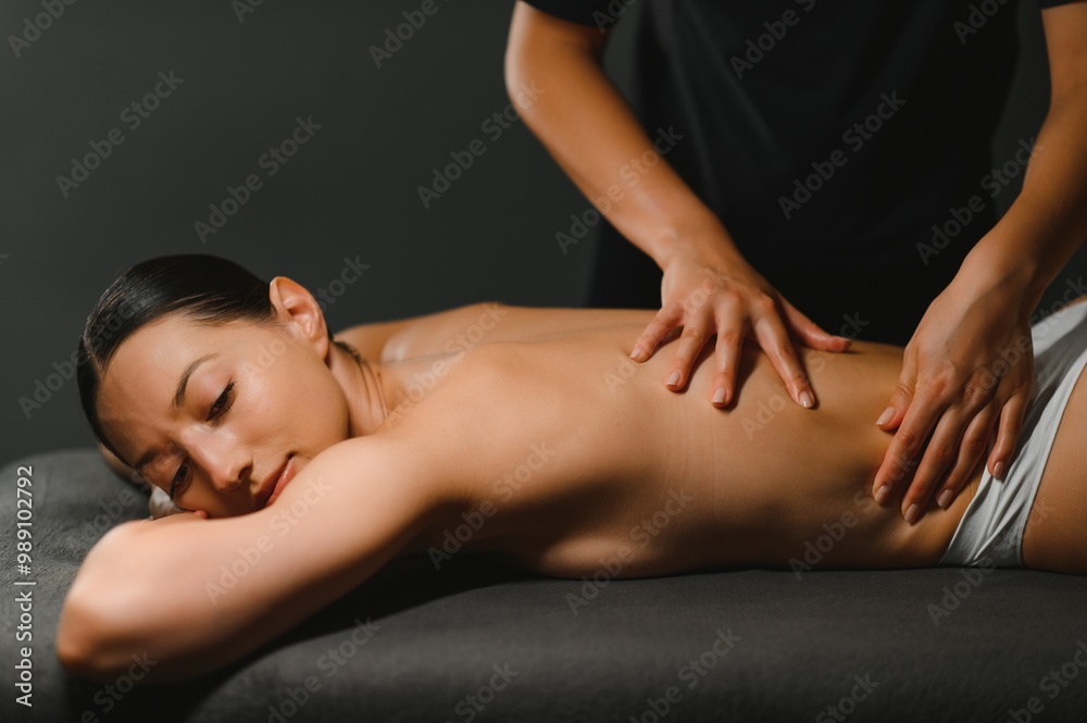 Masseur doing massage on woman body in the spa salon. Beauty treatment concept Masseur doing massage on woman body in the spa salon. Beauty treatment concept