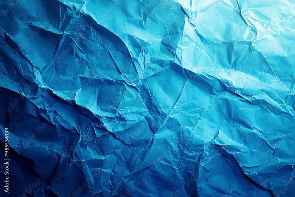 Fototapeta premium Close-up of Crumpled Blue Paper with Light Reflection