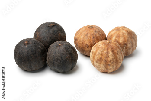 Whole dried black limes, loomi, and dried white limes on white background close up photo