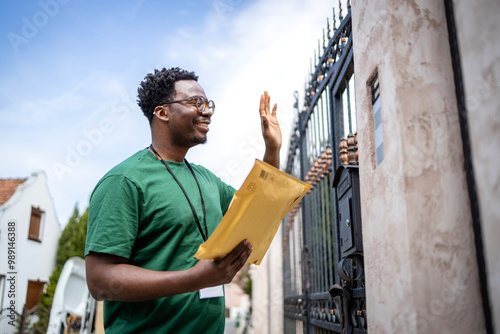 Shipment arrived. Postman waving to the recipient and delivering letters.