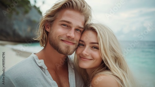 Close up portrait of blonde man and woman model couple on the beach feeling happy