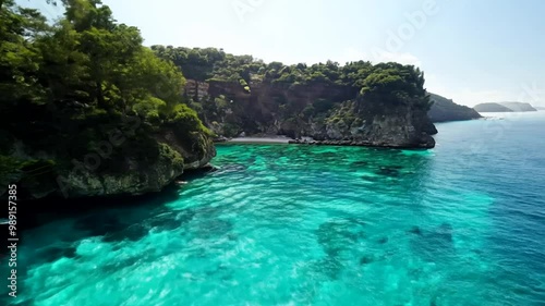 Wallpaper Mural Drone pullback of coastal cliffs covered by lush greens on clear turquoise waters, on a sunny day Torontodigital.ca