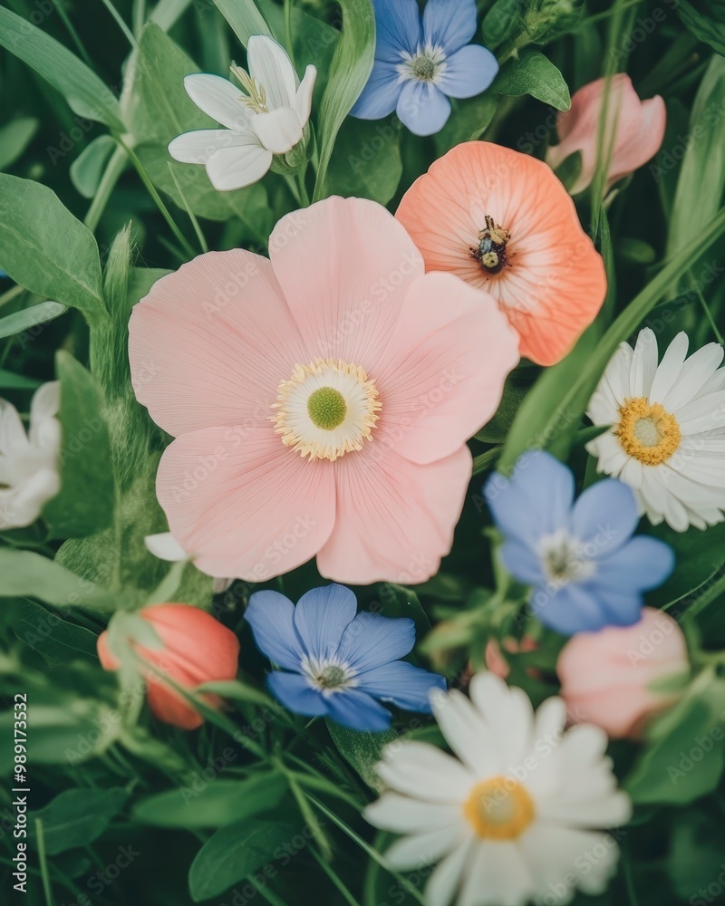 A bouquet of flowers with a pink flower in the center