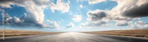 A scenic view of an empty road stretching towards a bright horizon under a blue sky and fluffy clouds, perfect for travel themes.