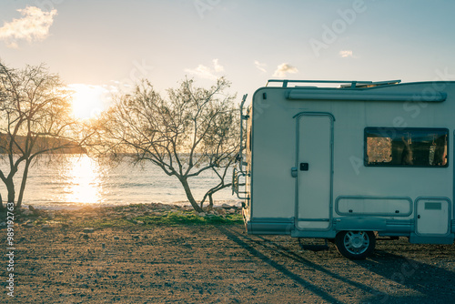 Obraz na płótnie Coastal sunset with recreational vehicle, Motorhome parked by the seaside under a dramatic sunset sky w salonie