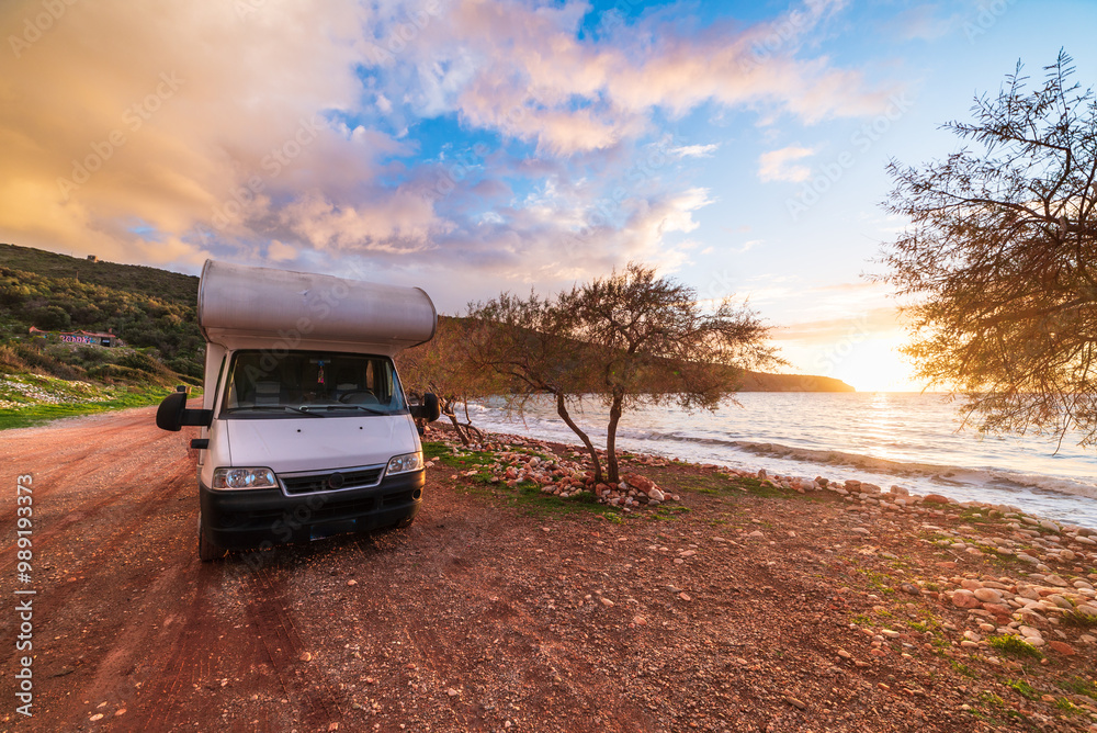 Coastal sunset with recreational vehicle, Motorhome parked by the seaside under a dramatic sunset sky Coastal sunset with recreational vehicle, Motorhome parked by the seaside under a dramatic sunset sky