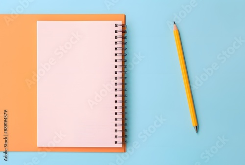 Pastel Blue and Pink Notebook with Pencil on Orange Background