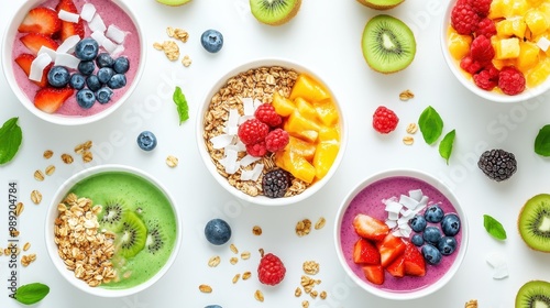 Colorful smoothie bowls topped with fruits and granola, showcasing healthy eating.