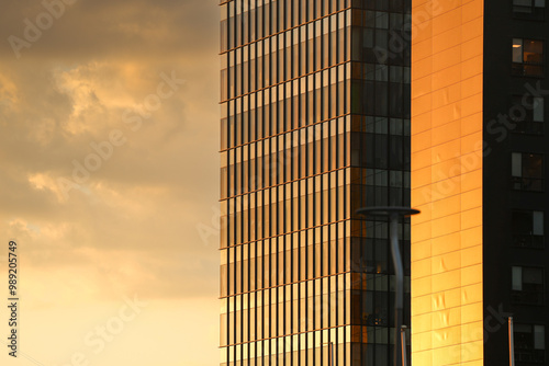 Obraz na płótnie Modern office building. Close up photo with the exterior glass steel facade of an office building places for companies headquarters offices. Corporate concept photo with sunset sky. w salonie