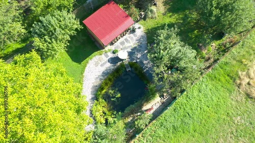 Garden pond. Relaxation zone with fish farming in an organic garden from above. Sustainable development in gardening and aquaculture.
