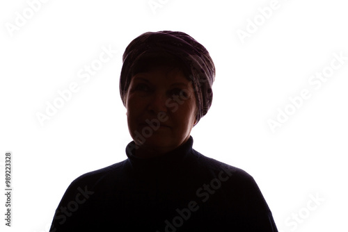 Dark silhouette of an elderly woman, pensioner in headdress - isolate