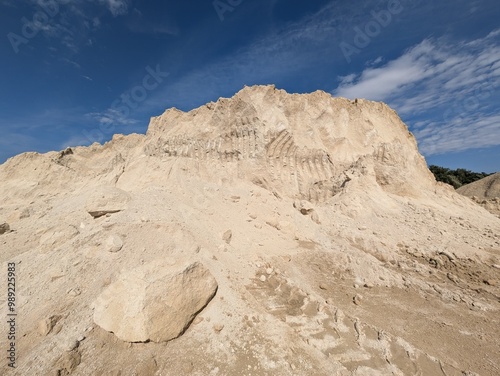 Massive pile of recycled sand in a quarry with excavator marks