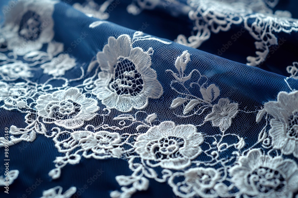 Obraz premium White Lace Detail on a Blue Fabric Background