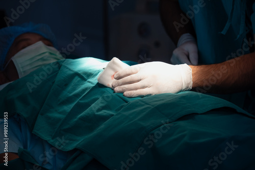 Professional doctors performing operation in surgery room