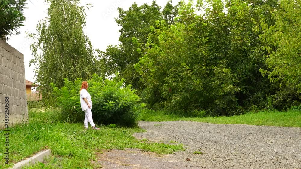 Senior woman walks relaxing outdoor on nature Senior woman walks relaxing outdoor on nature