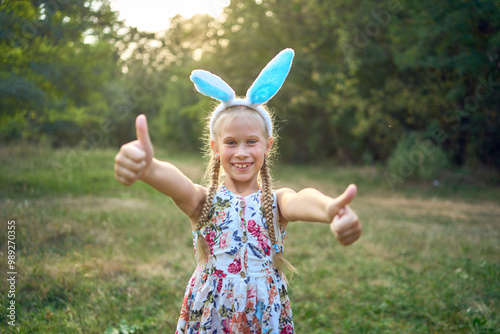 llittle girl  play bunnies on an Easter egg hunt photo