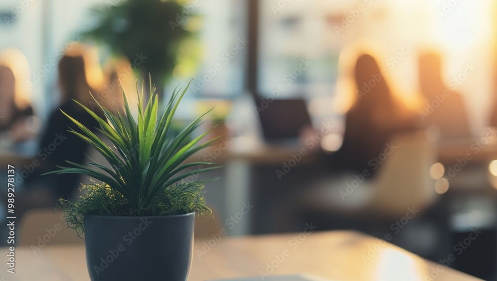 A blurred background of an office with business people in the foreground, sitting at desks and working on laptops In front is a large plant that adds greenery to the space Generative AI A blurred background of an office with business people in the foreground, sitting at desks and working on laptops In front is a large plant that adds greenery to the space Generative AI