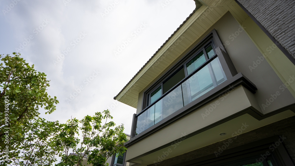 Seemingly framing the contemporary home is a nearly clear, black sky that appears ready to pour.