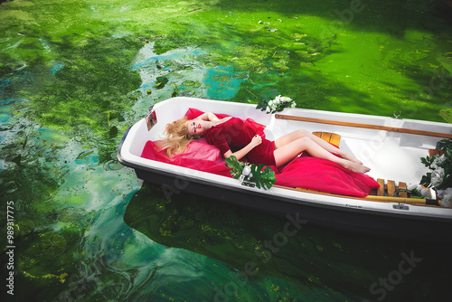boat on the water with woman in red dress