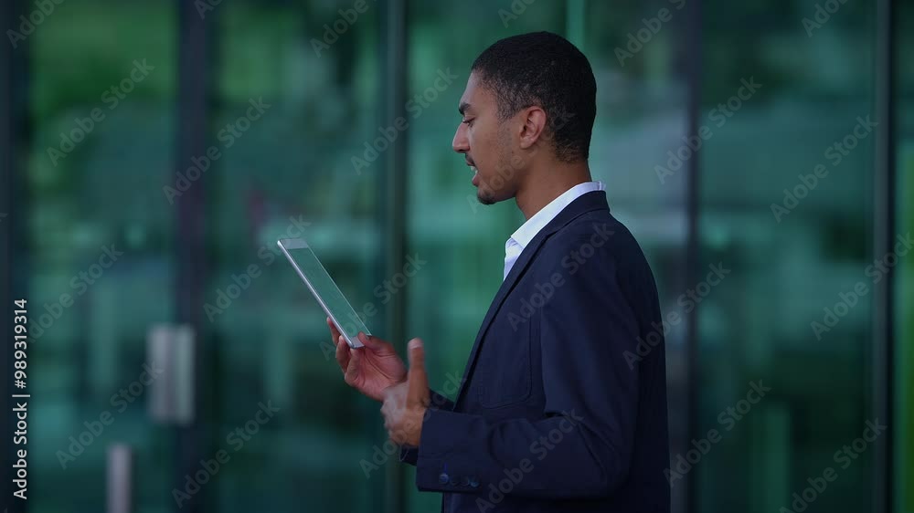 A Businessman Engaged with a Tablet in a Modern Office Infrastructure and Environment
