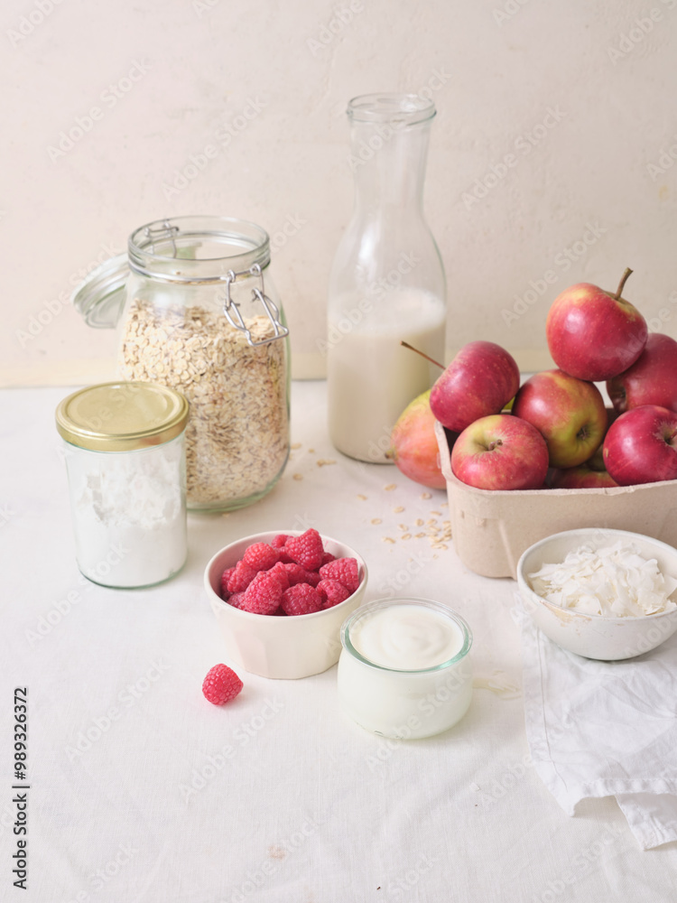 Ingredients for making overnight oats or a porridge bowl. Grains, fruits, berries and dairy products. White background Ingredients for making overnight oats or a porridge bowl. Grains, fruits, berries and dairy products. White background