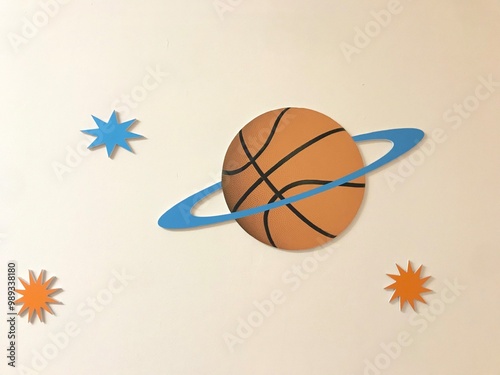 A blueringed basketball is on a starsurrounded planet photo