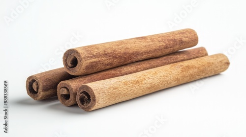 Four cinnamon sticks arranged in a triangle on a white background.