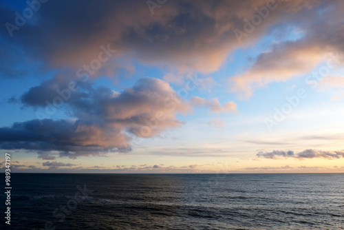 sunset over the ocean, calm sea, gradient sky, beautiful clouds