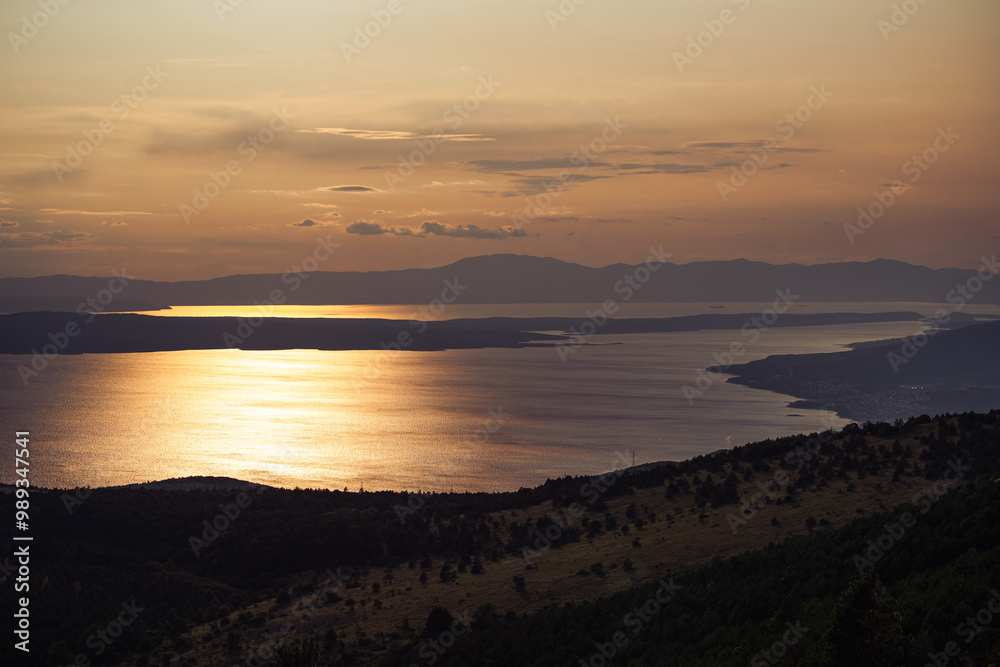 The light of the setting sun is reflected in the water of the Croatian Adriatic coast. The light of the setting sun is reflected in the water of the Croatian Adriatic coast.