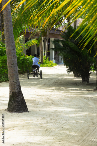 Room service tricycle transportation in a tropical tourist resort garden