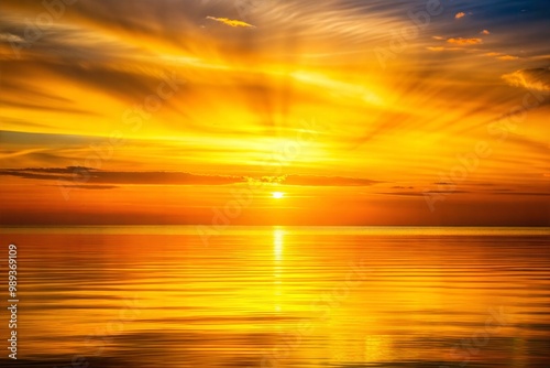 Golden sunset over ocean with reflections in water