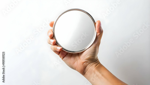 A hand holding a round mirror on a white background