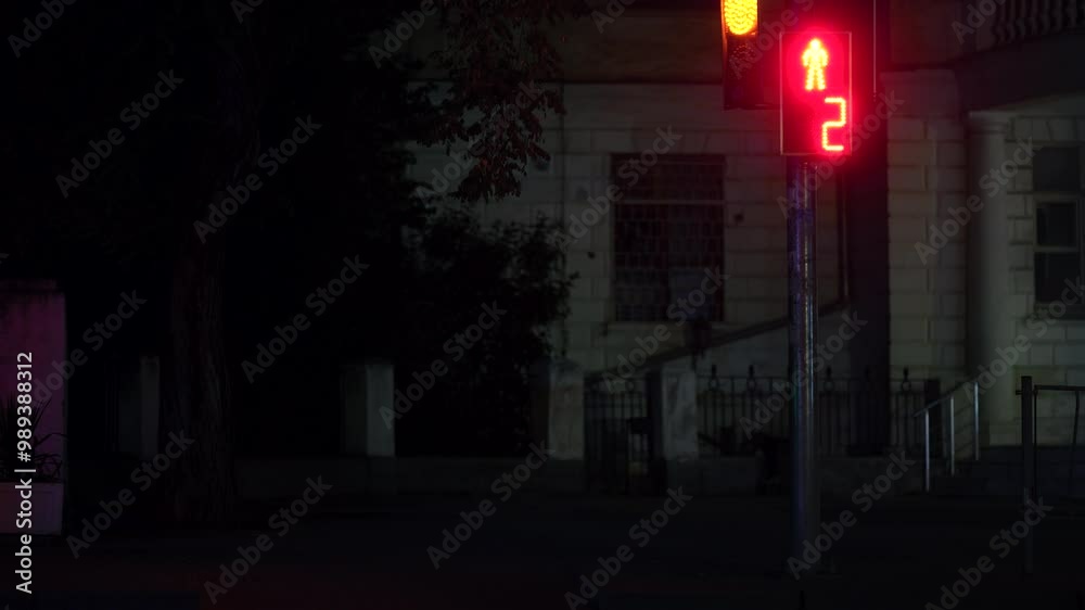 Cinematic night street. The urban color. Bright LED traffic light. The old building. Pedestrian crossing. The road is almost empty. A car interchange. Late evening. A sign with numbers. Cinematic night street. The urban color. Bright LED traffic light. The old building. Pedestrian crossing. The road is almost empty. A car interchange. Late evening. A sign with numbers.