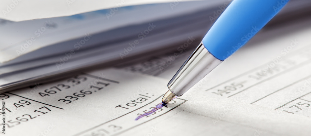 Accounting document with pen, money, coins and checking financial chart. Concept of banking, financial report and financial audit. Accounting document with pen, money, coins and checking financial chart. Concept of banking, financial report and financial audit.