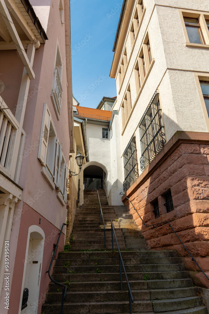 narrow street with a white building and a red roof narrow street with a white building and a red roof
