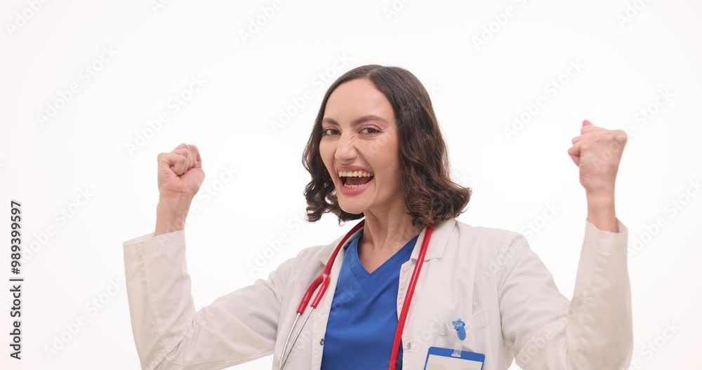 Happy woman doctor in uniform waves fists celebrating success on white. Cheerful female medic expresses satisfaction with successful treatment Happy woman doctor in uniform waves fists celebrating success on white. Cheerful female medic expresses satisfaction with successful treatment