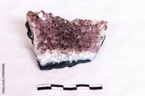 Crystals from an Amethyst geode on a white background with a 5cm scale photo