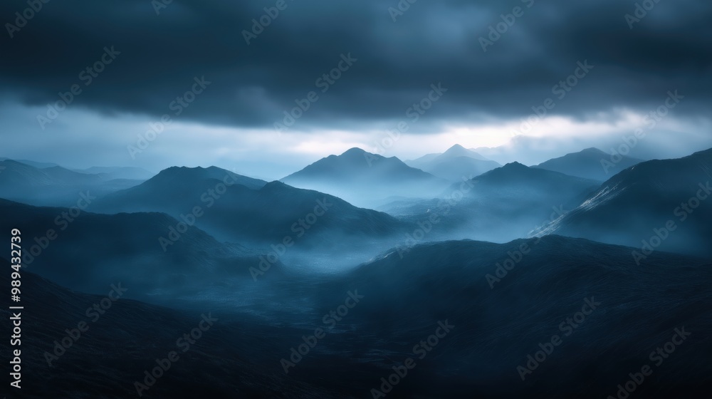 A dramatic mountain range enveloped in mist, with dark clouds overhead and faint sunlight. A dramatic mountain range enveloped in mist, with dark clouds overhead and faint sunlight.