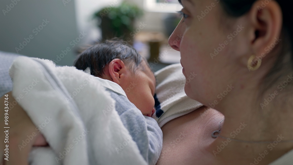 Side view of a mother gently holding her newborn baby close to her chest, capturing the deep connection, warmth, and security shared between mother and child in a nurturing environment Side view of a mother gently holding her newborn baby close to her chest, capturing the deep connection, warmth, and security shared between mother and child in a nurturing environment